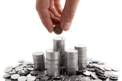 Hand adding coins Stock Photos