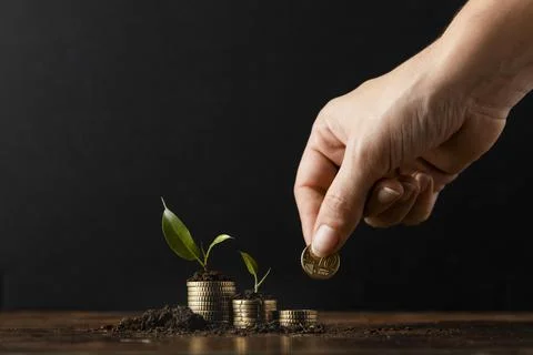 Hand adding coins stack covered dirt plants Resolution and high quality Stock Photos