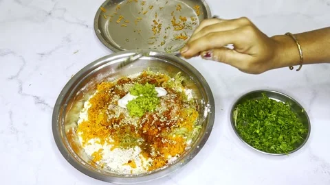 Hand adding elements into the veggie mixture Stock Footage 307901490