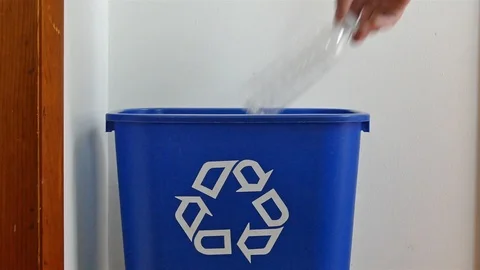 Hand is adding empty plastic bottles to recycling bin Stock Footage 106190914