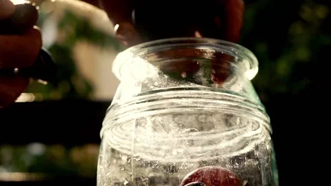 Hand adding fruits to the jar, super slow motion Stock Footage 119369542