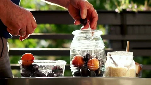 Hand adding fruits to the jar, super slow motion Stock Footage 119369834