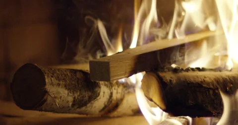 Hand adding more wood into the fire Stock Footage 56920129