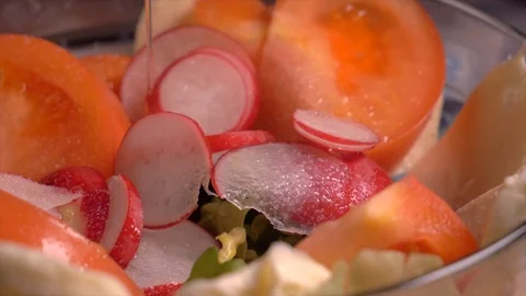 Hand adding oil in salad with vegetables in glass bowl, slow motion. closeup Stock Footage 103369928