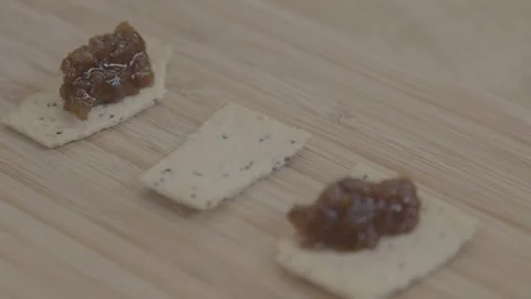 Hand Adding Relish to Crackers on Wooden Board at Sydney Market Food Stall Stock Footage 345715927