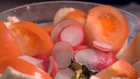 Hand adding salt in salad with vegetables in glass bowl, slow motion. closeup Stock Footage 103372249