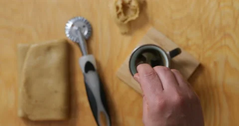 Hand adding sugar to coffee during dessert prep. Stock Footage 236558653