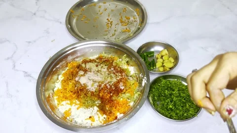 Hand adds ingredient to vegetable mix in Indian kitchen Stock Footage 307901479