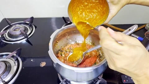 Hand Adds Paste to Simmering Base with Ladle Stock Footage 312725092