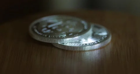 Hand Adds Silver Bitcoin To Stack On The Table. close up, selective focus Stock Footage 197626313