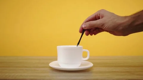 Hand adds sugar to a cup of coffee and stirring drink Stock-Footage 150402729