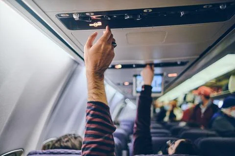 Hand up to adjust console panel aircraft, selective focus. Travel concept 스톡 사진