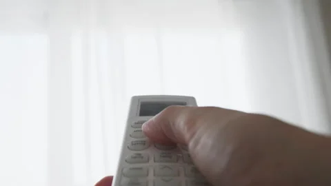 Hand adjusting air conditioner settings with remote control at home, illust.. Stock Footage 342762454