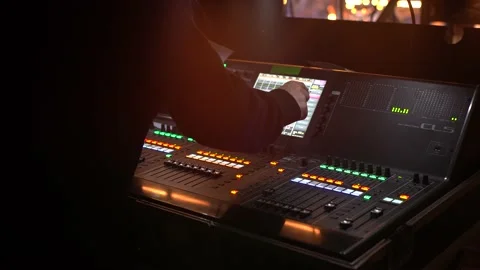Hand adjusting audio mixer. Audio engineer operating mixing console with hands Stock-Footage 156175683