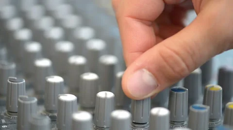 Hand adjusting audio mixer buttons Stock Footage 52232879