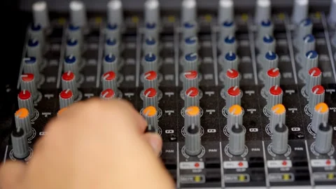 Hand Adjusting Audio Mixer Faders in Professional Recording Studio Stock Footage 306973153