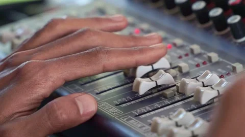 Hand adjusting audio mixer faders, sound engineering console with sliders Stock Footage 344432247