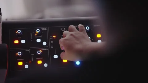 Hand Adjusting Audio Mixing Console Knobs in Dark Recording Studio Setting Stock-Footage 339031660