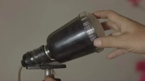 Hand adjusting a black studio flash lamp, detailed close-up of rotating equ.. Stock Footage 318628008
