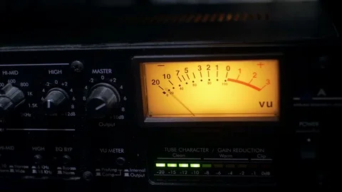Hand adjusting the buttons on a functioning audio compressor in a sound Stock Footage 70822264