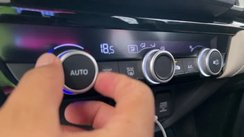 Hand Adjusting Car Climate Control Temperature on Modern Vehicle Dashboard Panel Stock Footage 335149339