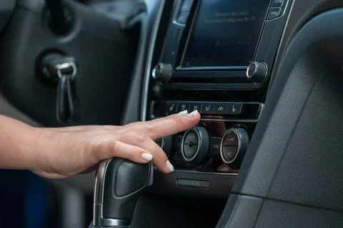 Hand adjusting car climate control air conditioning panel Фото