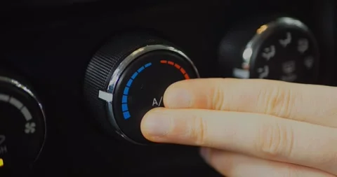 Hand adjusting the climate control knob in a car, turning for temperature... Stock Footage 313949180