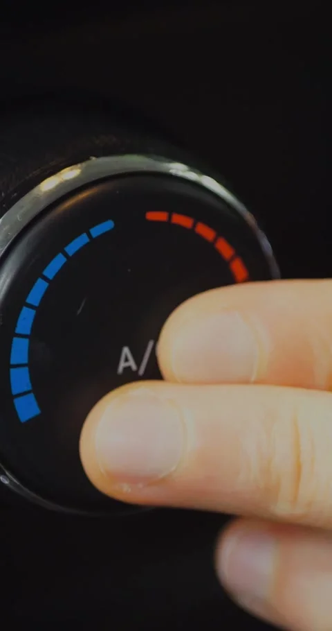 Hand adjusting the climate control knob in a car, turning... Stock-Footage 344454965