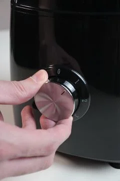 Hand adjusting coffee grinder settings 写真素材