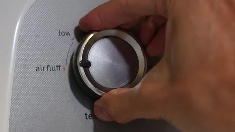 Hand Adjusting Dryer's Temperature Knob Stock Footage 264640046