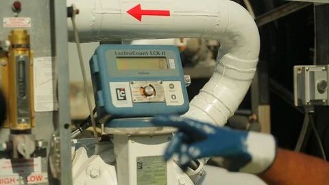 Hand adjusting fuel pump instrument dial at airport or dock 2 Stock Footage 123729706