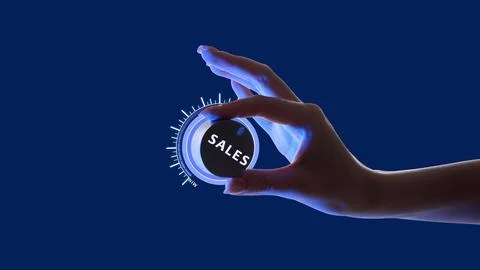 Hand adjusting glowing dial labeled SALES against blue background. Control and Stock Photos