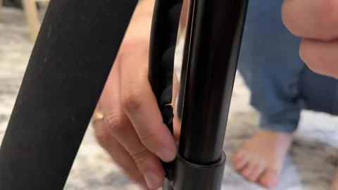 Hand adjusting height lock on tripod leg, camera support setup and photography Video stock 337121394