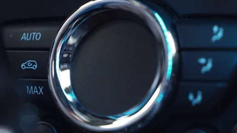 Hand adjusting the internal temperature of the car by turning the temperature Stock Footage 114020775