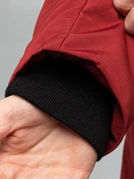 Hand adjusting jacket cuff with knit band Stock Photos