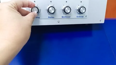 Hand Adjusting a Knob on a Control Panel Showcasing Precision and Technical.. Stock Photos