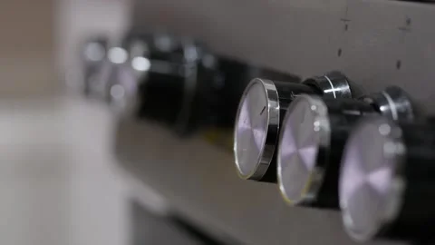 A hand adjusting knobs on a metallic panel. Close up, zoom in. Video stock 265892624