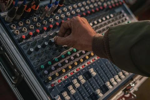 Hand adjusting knobs on a sound mixing console Stock Photos