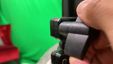 Hand adjusting locking screw handle to loosen and lock camera tripod pole Stock Footage 247893663