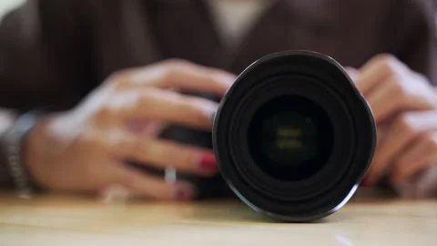 Hand adjusting modern professional camera Stock Footage 140036739