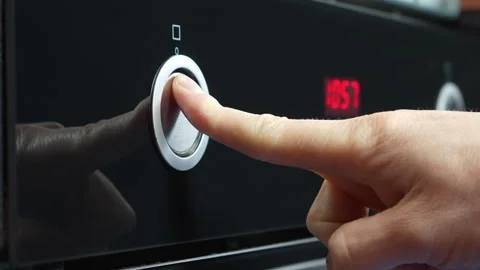 Hand Adjusting Oven Control Knob for Temperature Setting Stock Footage 305658786