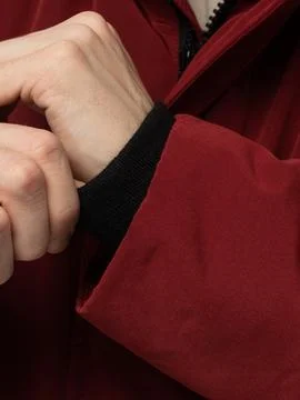 Hand adjusting red jacket cuff band Stock Photos