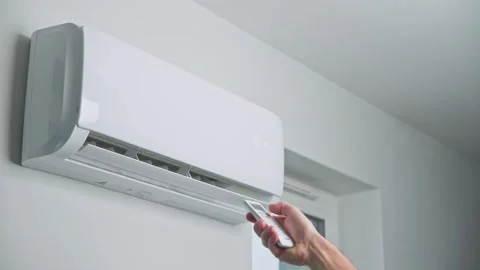 Hand adjusting temperature on air conditioner Stock Footage 168323401