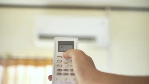 Hand adjusting temperature on air conditioner Stock Footage 322205479