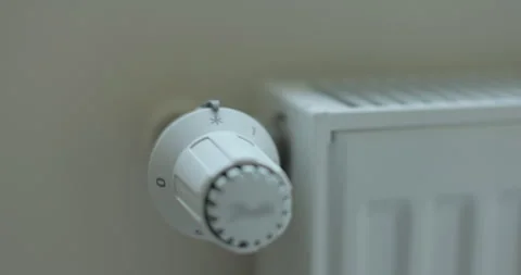 Hand adjusting temperature on heating radiator thermostat. Video stock 293355572