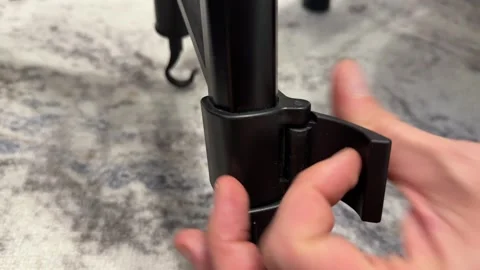 Hand adjusting tripod leg lock close up, camera stand height setup and Video stock 337121379