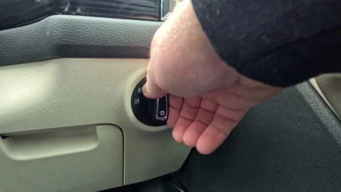 Hand Adjusting Vehicle Light Switch Inside Automobile Stock-Footage 335098744