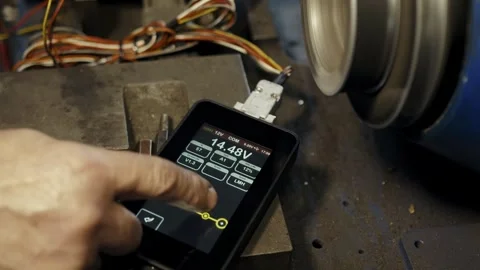 Hand adjusting voltage on device switches voltage measurement parameters on the Stock Footage 284545721