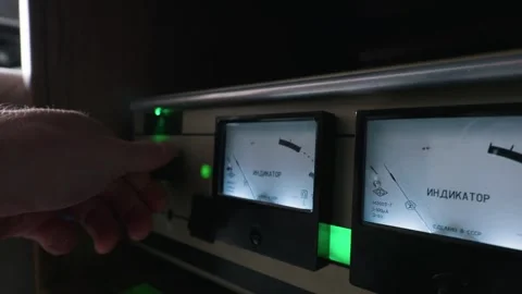 Hand Adjusting Volume Control on Vintage Analog Audio Amplifier Vu Meters Stock Footage 334131162