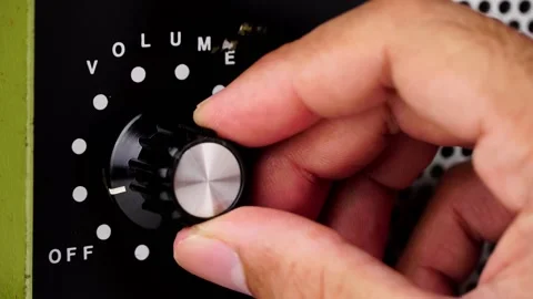 Hand adjusting volume control.Use hand to adjust the volume Stock Footage 169243418